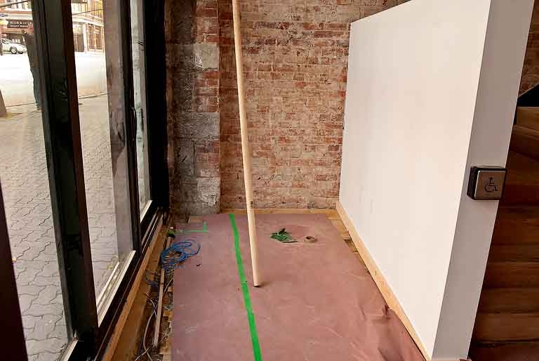 Main floor podcasting studio with a street view.