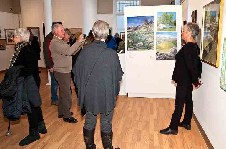 Artist posing for a shot with her art.