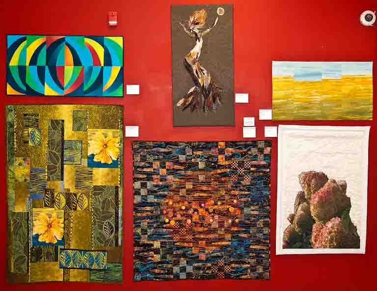 Bottom middle piece, Nine Patch on Jupiter is Susan Warner Keene's Juror's Prize piece in the OMAH fiber art show.