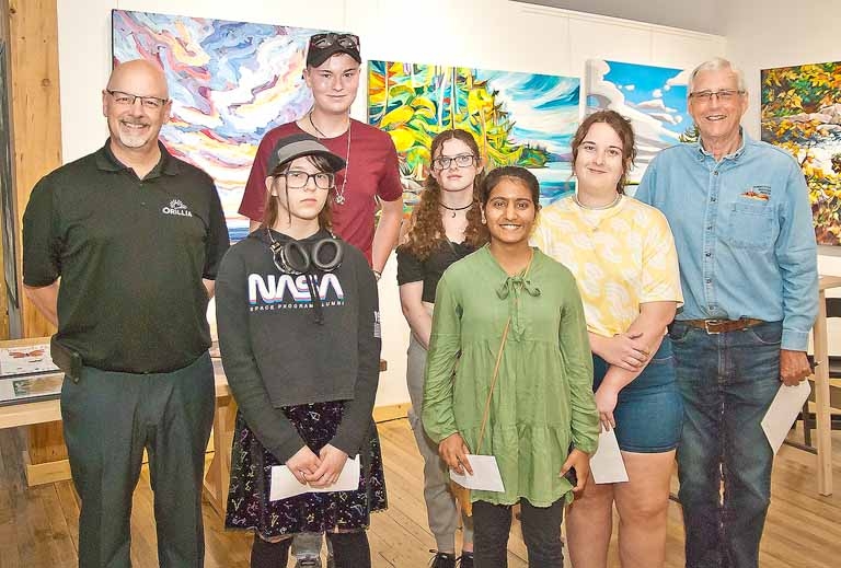 Orillia councillor Dave Campbell and Sustainable Orillia's Fred Larsen with high school students who had art chosen for  inclusion in the 2024 calendar - Biodiversity: It’s All Around Us