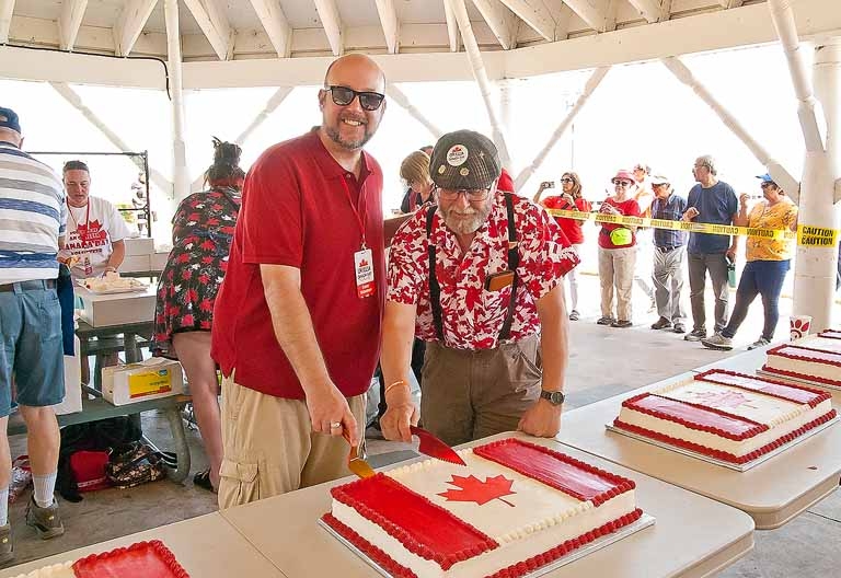 2024 Canada Day Comiittee fundraising and entertainment coordinator Derick Lehmann and chair Brian Hare making the first cut.
