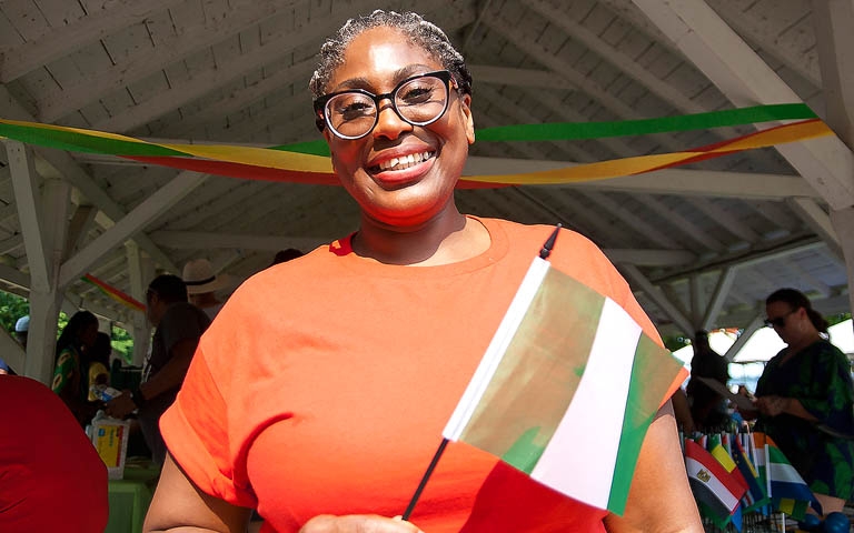 2024 CommunityFest Organizer Alasoba Kelsy-Braide holding Nigerian flag