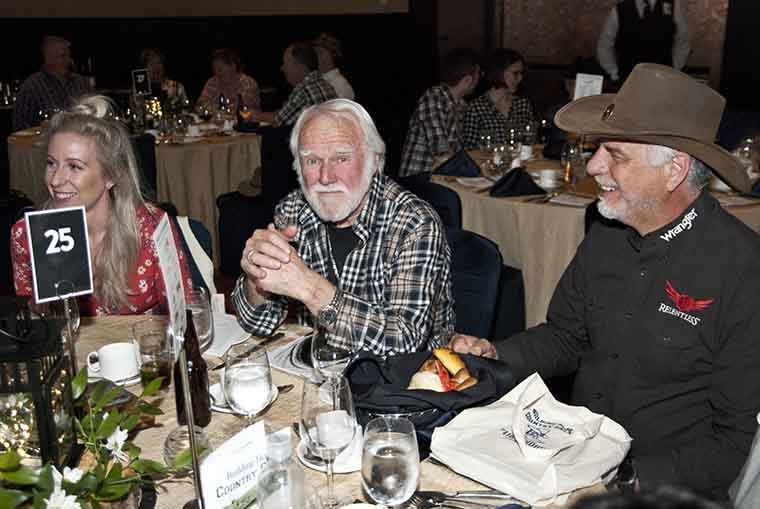 Dave Beckett, center, donated art for auction.