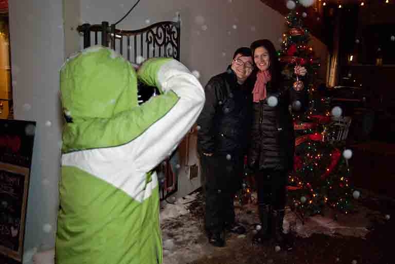 Deb Halbot taking a picture of Clayton Johnson and Tammy Henry at Friday night's annual Merry Streets Alive Christmas