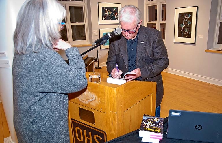 Fred Addis signing a copy of Gallinger: A Life Suspended.