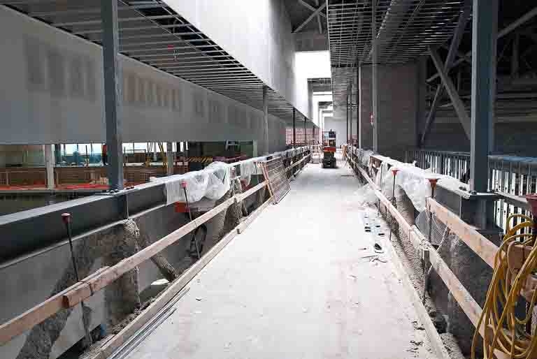 The track cuts through between the pool and gymnasium above the main concourse.