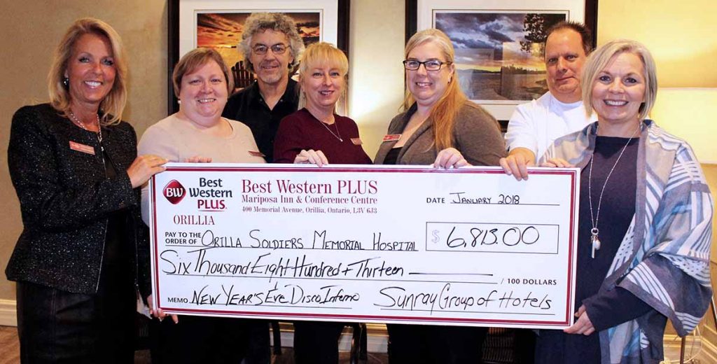 Organizers of the Mariposa Inn  New Year’s Eve Disco Inferno  present a cheque for $6,813 to the OSMH Foundation